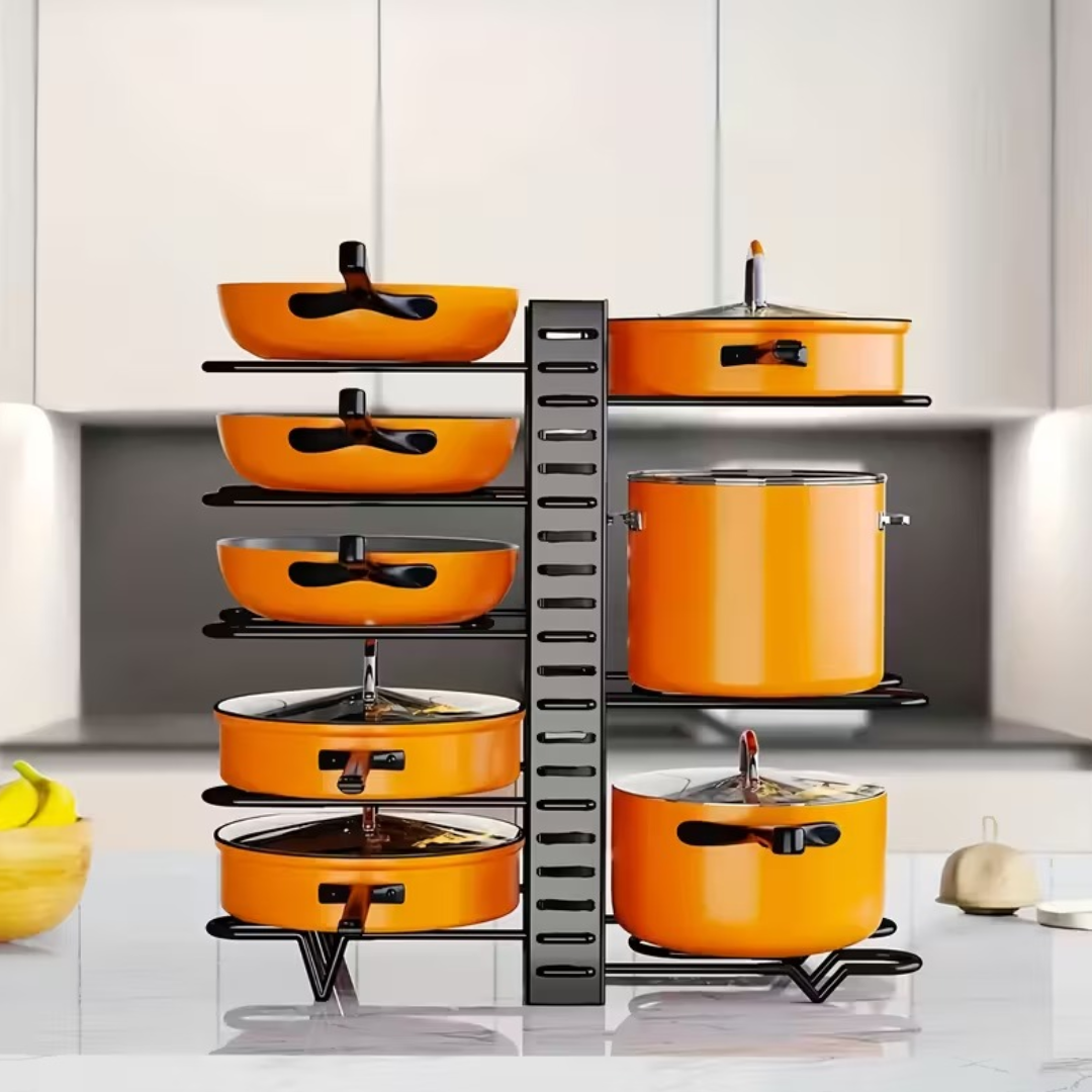 Set of orange pots and pans on a metal rack in a kitchen.